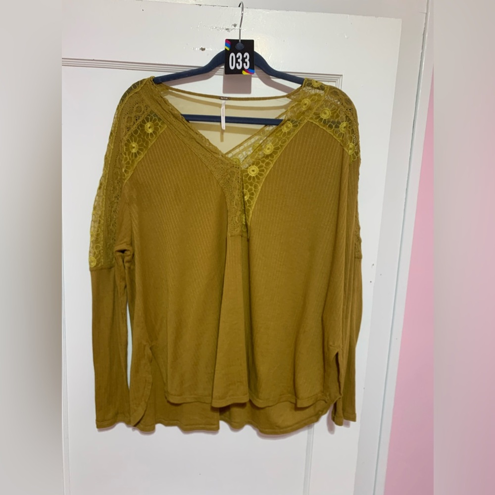 Free people shirt with awesome detailing V-neck. It is a high low size large.